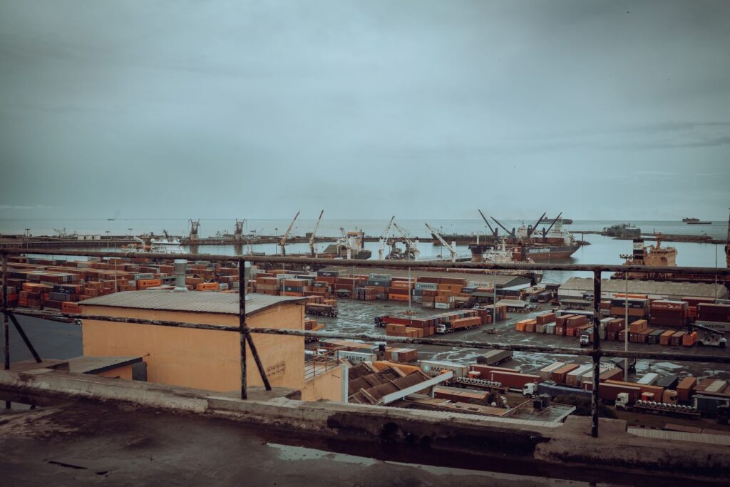 West African commercial port with shipping containers and cranes